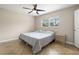 Comfortable bedroom with neutral walls, tile flooring and a ceiling fan at 11029 Clay Pit Rd, Tampa, FL 33610