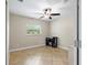 Office/bedroom showcasing tile floors, a ceiling fan, and a window at 11029 Clay Pit Rd, Tampa, FL 33610