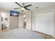 Cozy bedroom with an ensuite bathroom, a ceiling fan, and ample closet space at 11029 Clay Pit Rd, Tampa, FL 33610