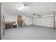 Spacious garage with painted floor, storage shelves and an insulated garage door at 11029 Clay Pit Rd, Tampa, FL 33610