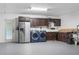 Garage space with laundry machines, cabinetry, utility sink, and gray-painted floor at 11029 Clay Pit Rd, Tampa, FL 33610