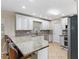 Well-lit kitchen with granite countertops, stainless steel appliances, and a convenient breakfast bar at 11029 Clay Pit Rd, Tampa, FL 33610