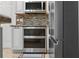Gourmet kitchen showing stainless steel appliances, including a double oven, and custom cabinetry at 11029 Clay Pit Rd, Tampa, FL 33610