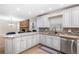 Bright kitchen featuring granite countertops, mosaic backsplash, and stainless steel appliances at 11029 Clay Pit Rd, Tampa, FL 33610