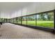Expansive screened-in lanai overlooking a lush backyard, offering a tranquil outdoor living experience at 11029 Clay Pit Rd, Tampa, FL 33610