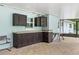 Covered lanai featuring a built-in bar area, ideal for outdoor entertaining and casual dining at 11029 Clay Pit Rd, Tampa, FL 33610