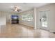 Bright living room showcasing a decorative glass front door and neutral tile floors at 11029 Clay Pit Rd, Tampa, FL 33610