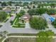 Aerial view of a charming home on a corner lot with well-maintained landscaping and mature trees in a friendly neighborhood at 11415 Bright Star Ln, Riverview, FL 33569