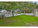Spacious backyard featuring grass, trees, and a white privacy fence at 11415 Bright Star Ln, Riverview, FL 33569