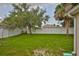 Large grassy backyard surrounded by a white vinyl fence, offering privacy and space for outdoor activities at 11415 Bright Star Ln, Riverview, FL 33569