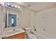 Bathroom featuring a single vanity, a mirror with lighting, toilet, and tub with shower head at 11415 Bright Star Ln, Riverview, FL 33569