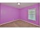 Carpeted bedroom with purple walls and a window at 11415 Bright Star Ln, Riverview, FL 33569
