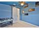 The blue bedroom features a sliding barn door and unique recessed wall displays for decorative purposes at 11415 Bright Star Ln, Riverview, FL 33569