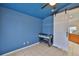 This is a blue bedroom with a sliding barn door, ceiling fan, and neutral tile floor at 11415 Bright Star Ln, Riverview, FL 33569