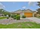 Attractive single-story home with verdant bushes and a colorful two-car garage at 11415 Bright Star Ln, Riverview, FL 33569