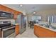 Well-lit kitchen with stainless steel appliances, tile floors, and adjacent breakfast nook at 11415 Bright Star Ln, Riverview, FL 33569