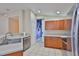 Spacious kitchen with stainless appliances, ample counter space, and tiled floor leading to hallway at 11415 Bright Star Ln, Riverview, FL 33569