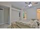 Airy living room with ceramic tile flooring, ceiling fan, and neutral decor at 11415 Bright Star Ln, Riverview, FL 33569