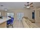 Bright living room with tile floors, ceiling fan, and sliding glass doors to the outside at 11415 Bright Star Ln, Riverview, FL 33569