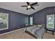Carpeted main bedroom with ceiling fan and multiple windows, creating a bright and airy space at 11415 Bright Star Ln, Riverview, FL 33569