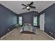Main bedroom featuring a ceiling fan, carpet floor, and two windows for natural light at 11415 Bright Star Ln, Riverview, FL 33569
