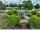 Community playground with a slide and climbing structure, surrounded by lush greenery and towering pines at 11415 Bright Star Ln, Riverview, FL 33569