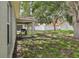 Spacious backyard featuring a covered patio with a grill, lush lawn, and a secure white fence at 11708 Crest Creek Dr, Riverview, FL 33569