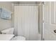 Bathroom featuring a striped shower curtain, a toilet and a towel rack at 11708 Crest Creek Dr, Riverview, FL 33569
