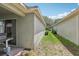 Exterior side yard featuring green grass and access between two buildings at 11708 Crest Creek Dr, Riverview, FL 33569