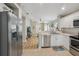 Open kitchen with stainless steel appliances, tile backsplash, and an eat-in breakfast bar at 11708 Crest Creek Dr, Riverview, FL 33569