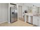 Bright kitchen with stainless steel appliances, tiled floor, and an open view to the living area at 11708 Crest Creek Dr, Riverview, FL 33569