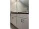 Bathroom vanity featuring double sinks, granite countertops, and sleek chrome faucets at 11901 Castine St, New Port Richey, FL 34654