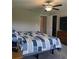 Comfortable bedroom featuring a ceiling fan, plush carpeting, and neutral walls at 11901 Castine St, New Port Richey, FL 34654