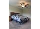 Cozy bedroom with a queen-size bed and a ceiling fan, ideal for relaxation at 11901 Castine St, New Port Richey, FL 34654