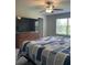 Comfortable bedroom featuring a large screen TV for entertainment and relaxation at 11901 Castine St, New Port Richey, FL 34654