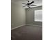 A cozy bedroom featuring neutral colors, wall-to-wall carpeting and a ceiling fan at 11901 Castine St, New Port Richey, FL 34654