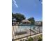 Community pool featuring lounge chairs with black metal fencing, and beautiful landscaping at 11901 Castine St, New Port Richey, FL 34654