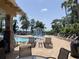 Community pool area with a splash pad, lounge seating, and palm trees at 11901 Castine St, New Port Richey, FL 34654