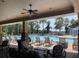 Covered poolside lounge area with ceiling fan, overlooking community pool and palm trees at 11901 Castine St, New Port Richey, FL 34654