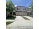 Exterior view of a townhome showcasing a two-car garage and well-maintained lawn at 11901 Castine St, New Port Richey, FL 34654