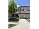 Townhome featuring two-car garage, neutral paint, and manicured landscaping at 11901 Castine St, New Port Richey, FL 34654