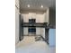 Modern kitchen featuring granite countertops, stainless steel appliances, and white cabinets at 11901 Castine St, New Port Richey, FL 34654