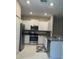 Kitchen with stainless steel appliances and white cabinetry at 11901 Castine St, New Port Richey, FL 34654