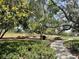 Outdoor picnic area with tables surrounded by mature trees and lush landscaping at 11901 Castine St, New Port Richey, FL 34654