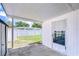 Covered back porch and patio area, with access to the fenced backyard, offering a great outdoor living space at 12033 82Nd Ave, Seminole, FL 33772