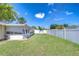 Wide view of the backyard with a white fence, offering ample space and privacy at 12033 82Nd Ave, Seminole, FL 33772