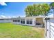 Large backyard view from the side, showing a covered porch and storage building at 12033 82Nd Ave, Seminole, FL 33772