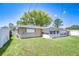 Expansive backyard featuring lush green grass and a charming enclosed patio at 12033 82Nd Ave, Seminole, FL 33772