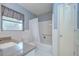 Bathroom showcasing a shower and tub combination, with a neutral color scheme at 12033 82Nd Ave, Seminole, FL 33772