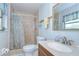 Tile bathroom with walk-in shower, white toilet, vanity, and ample lighting at 12033 82Nd Ave, Seminole, FL 33772